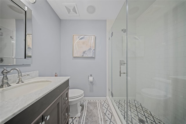 bathroom featuring vanity, toilet, baseboards, and a stall shower