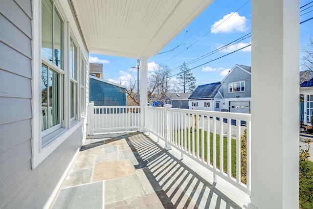 balcony featuring a residential view and covered porch