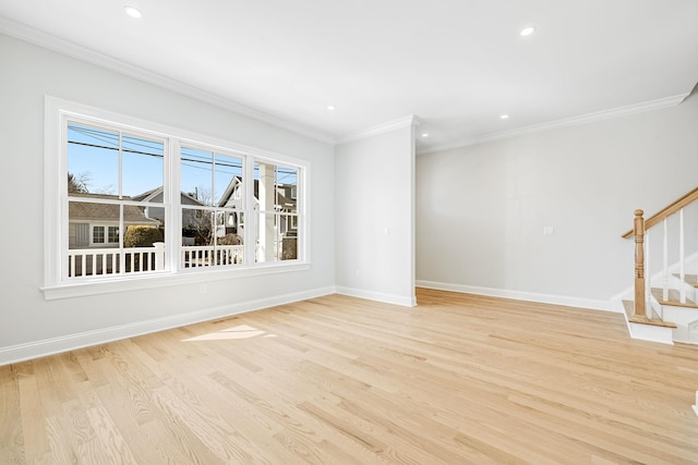 empty room with stairs, crown molding, light wood-style floors, and baseboards