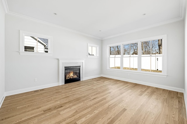 unfurnished living room with a fireplace, light wood finished floors, and ornamental molding