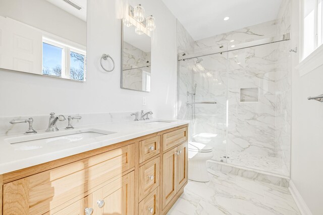 full bath with a sink, visible vents, toilet, and marble finish floor