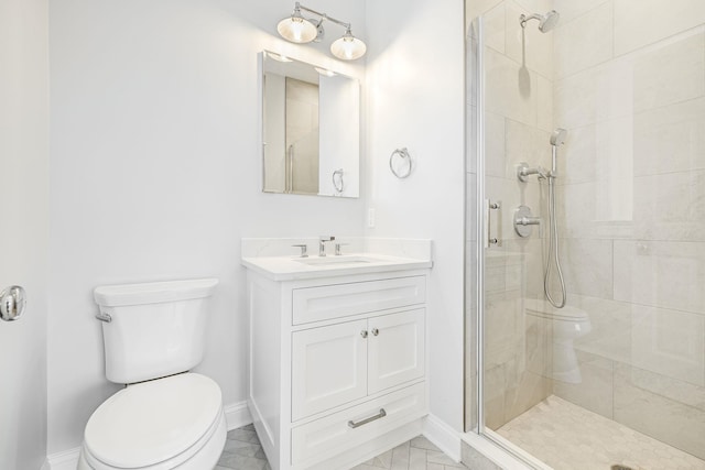 bathroom with baseboards, toilet, a stall shower, and vanity