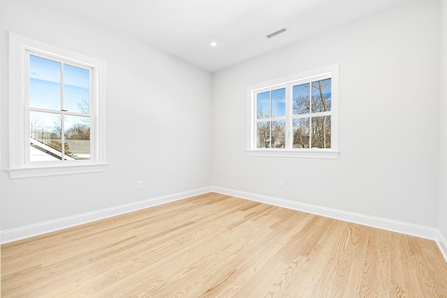 spare room with recessed lighting, visible vents, baseboards, and light wood-style flooring