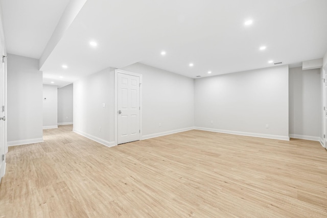 basement featuring recessed lighting, light wood-type flooring, and baseboards