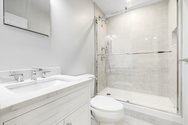 full bathroom featuring vanity, toilet, and a stall shower