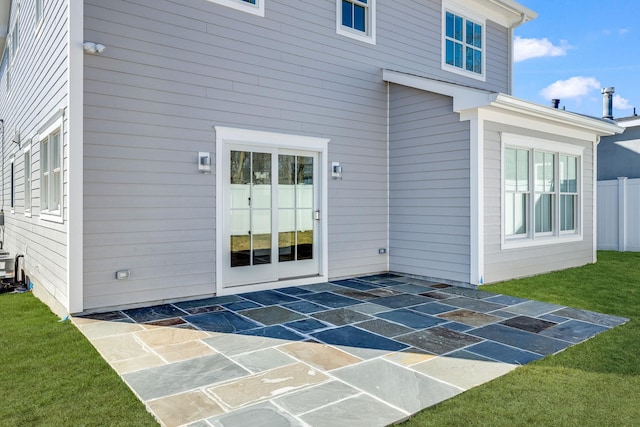 rear view of house with a lawn and a patio area