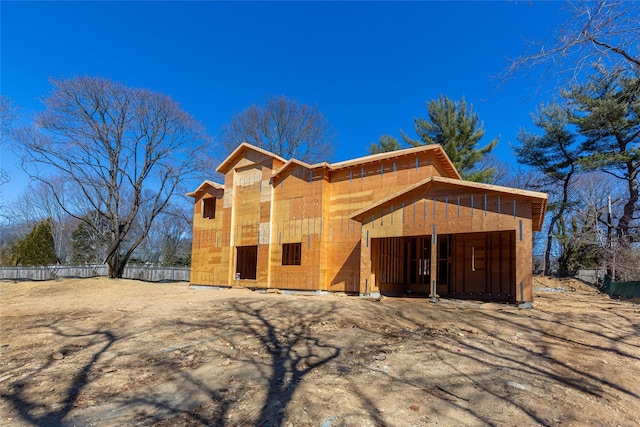 view of front of property featuring fence