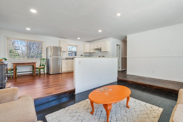 living room featuring baseboards, ornamental molding, baseboard heating, recessed lighting, and dark wood-style floors