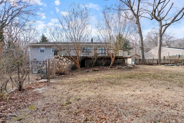 back of property with stairway, a deck, a chimney, and fence