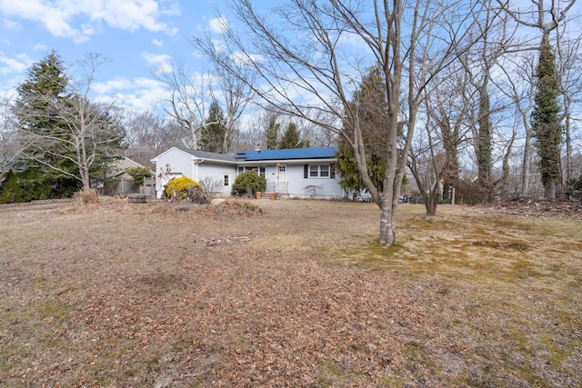 view of front of home with roof mounted solar panels