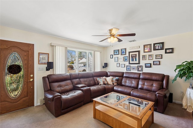 living area featuring visible vents, baseboards, ceiling fan, light colored carpet, and baseboard heating