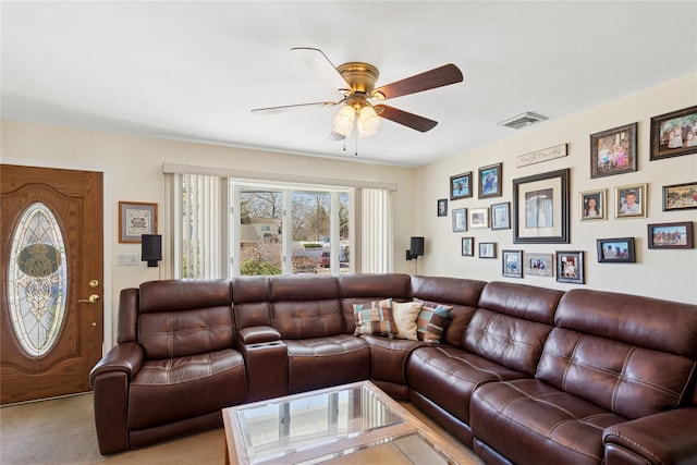 living area featuring carpet flooring, a ceiling fan, and visible vents