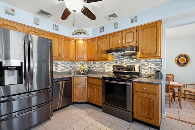 kitchen featuring tasteful backsplash, visible vents, under cabinet range hood, and stainless steel appliances