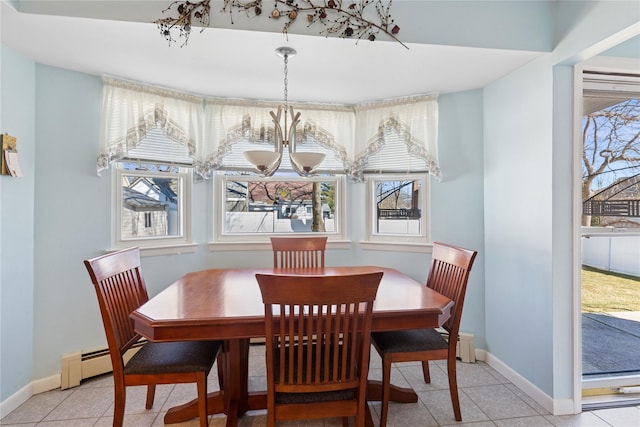 dining area featuring a baseboard heating unit, light tile patterned floors, and baseboards