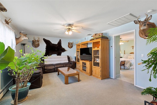 carpeted living area with visible vents, baseboard heating, and ceiling fan