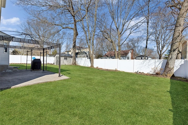 view of yard with a gazebo, an outdoor structure, a fenced backyard, and a patio area