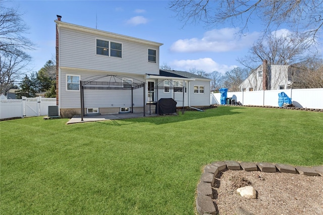 rear view of property with a gazebo, central AC unit, a yard, a fenced backyard, and a patio area