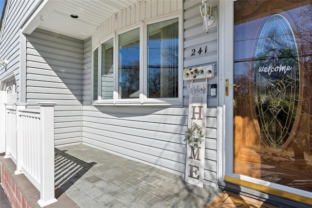 view of exterior entry featuring a porch