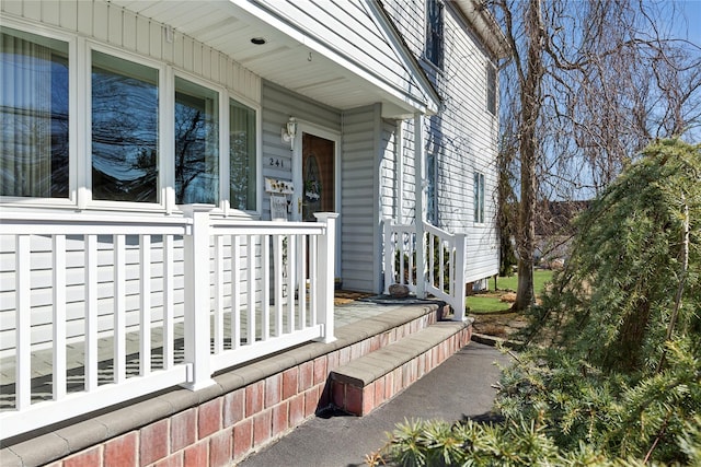 view of side of property with covered porch