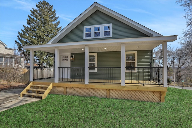 bungalow with covered porch and a front yard