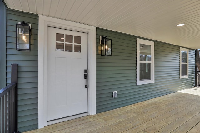 view of exterior entry with a porch