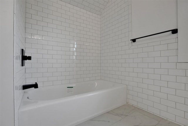 full bathroom with a bath and marble finish floor