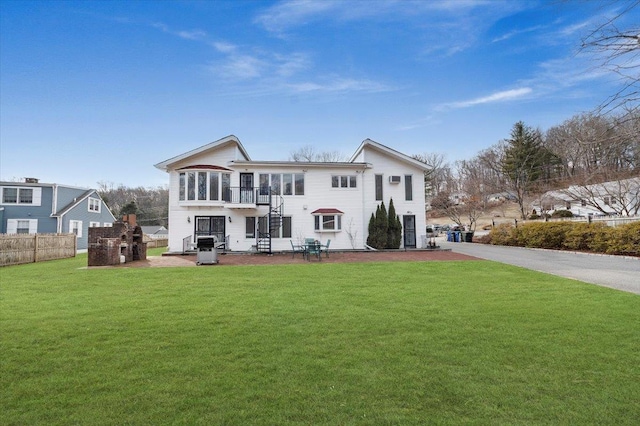 view of front of home featuring a patio, a front yard, and fence