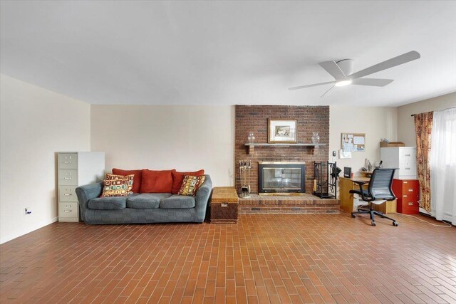 living area with a brick fireplace and ceiling fan