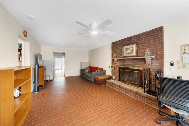 living room with a fireplace, brick floor, and ceiling fan