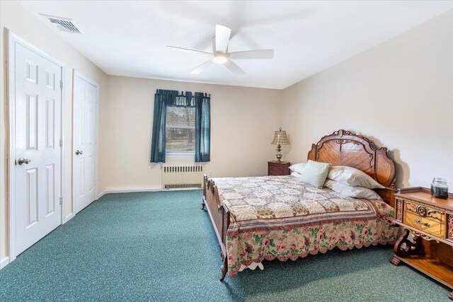 bedroom featuring radiator, a ceiling fan, visible vents, baseboards, and carpet flooring