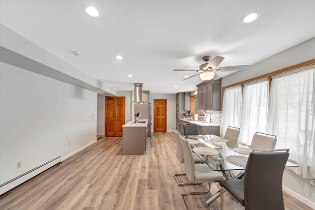 dining space featuring recessed lighting, baseboards, light wood finished floors, and a baseboard radiator