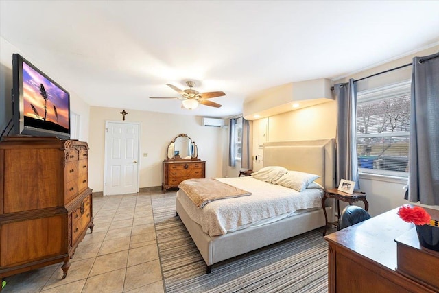 bedroom with light tile patterned flooring, baseboards, a wall mounted AC, and a ceiling fan