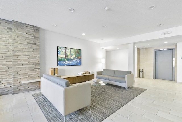 living room with elevator, light tile patterned floors, recessed lighting, and a textured ceiling