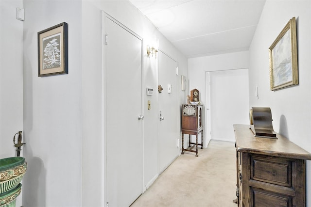 hallway with light colored carpet