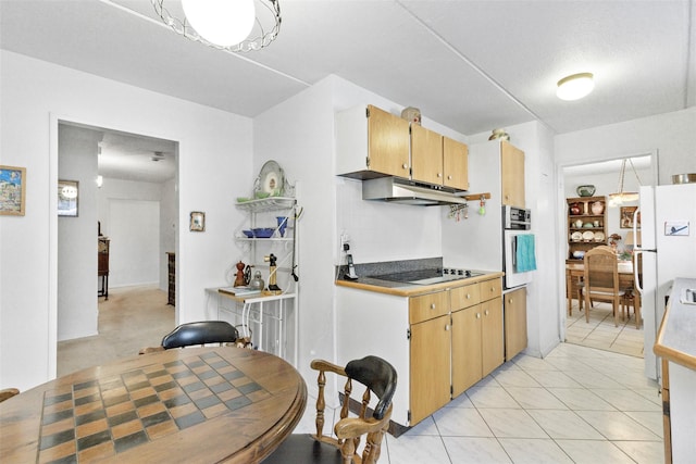 kitchen with under cabinet range hood, light tile patterned floors, and white appliances