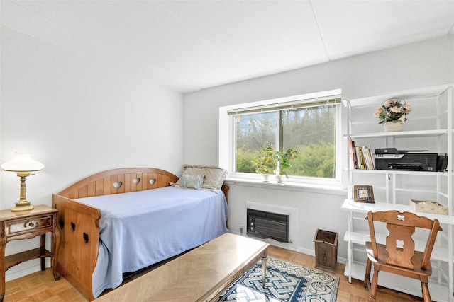 bedroom with heating unit and baseboards