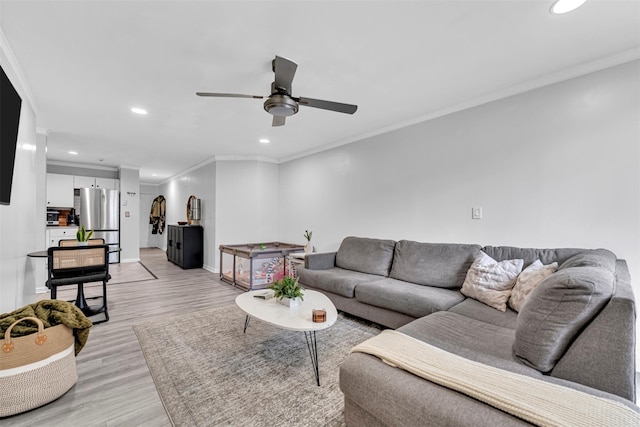 living room featuring recessed lighting, a ceiling fan, crown molding, and light wood finished floors