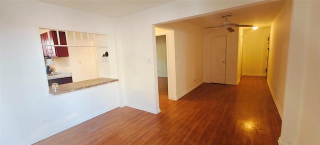 hall featuring wood finished floors and baseboards