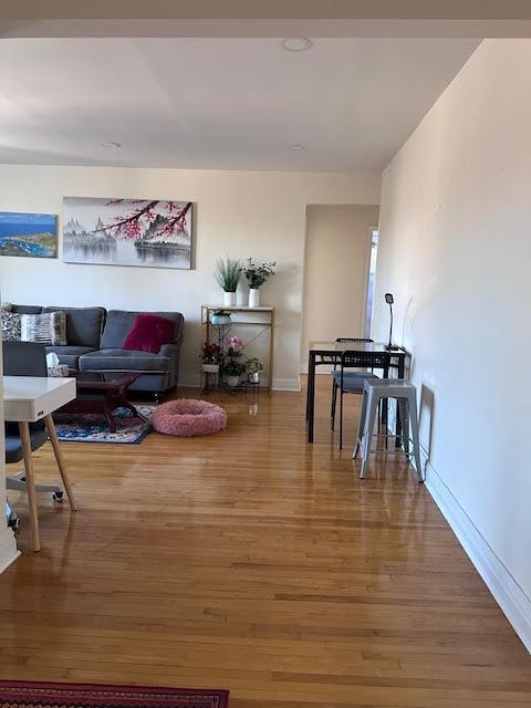 living room with baseboards and wood finished floors