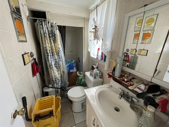 bathroom with a shower with curtain, tile walls, and tile patterned flooring