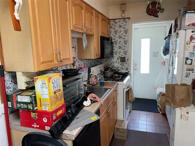 kitchen with backsplash, black microwave, white gas stove, dishwashing machine, and light tile patterned flooring