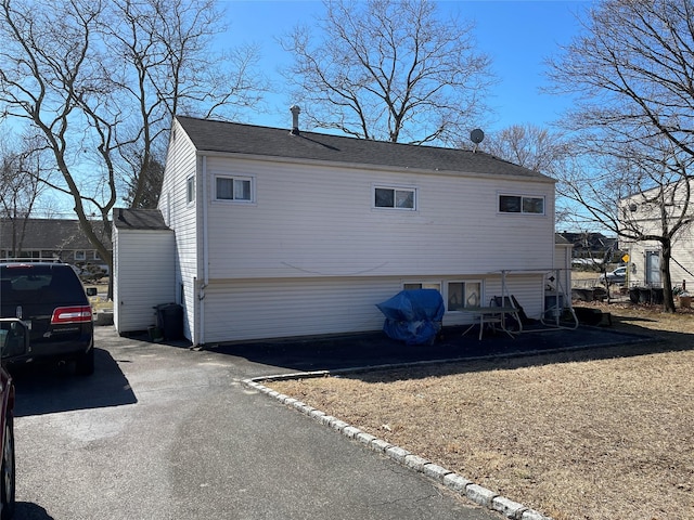 view of side of home with aphalt driveway