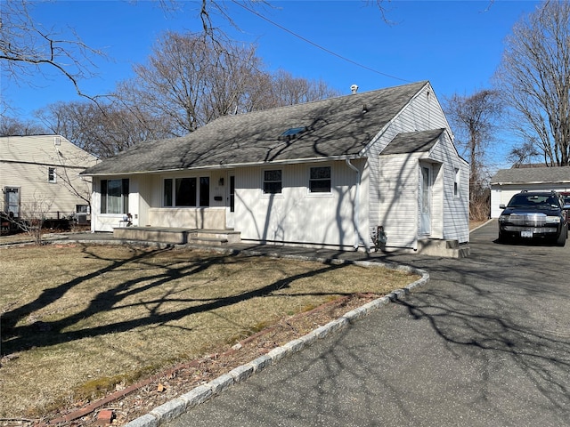 view of front of house with roof with shingles and entry steps