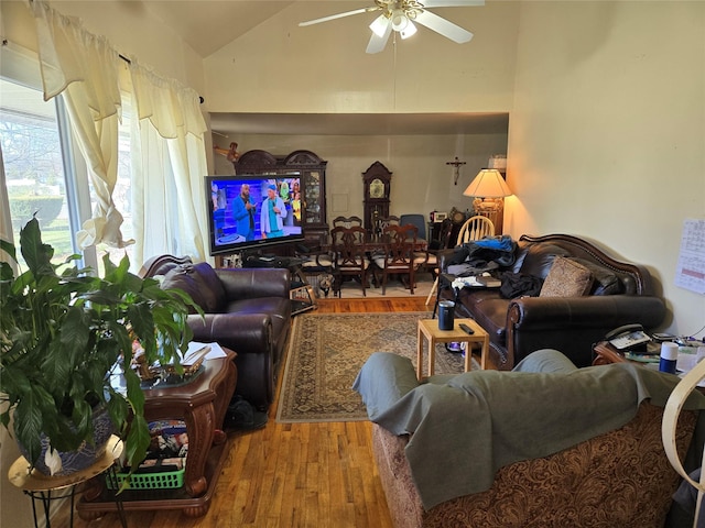living room featuring high vaulted ceiling, ceiling fan, and wood finished floors