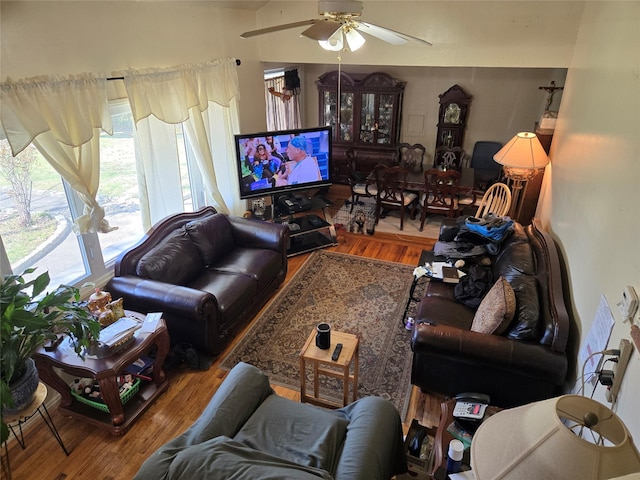 living room featuring vaulted ceiling, wood finished floors, and ceiling fan
