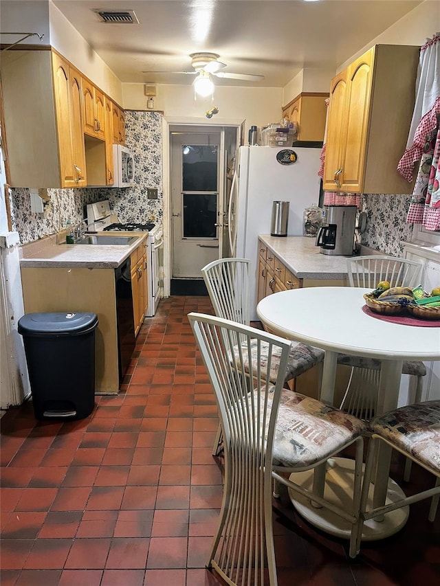 kitchen with decorative backsplash, white appliances, ceiling fan, light countertops, and dark tile patterned floors