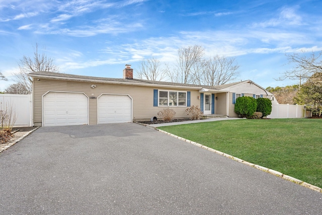 ranch-style house with fence, a front yard, a chimney, a garage, and driveway