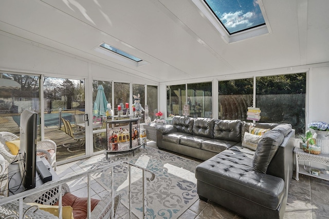 sunroom featuring lofted ceiling with skylight