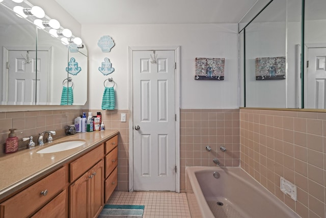 full bathroom featuring vanity, a garden tub, a wainscoted wall, tile patterned flooring, and tile walls