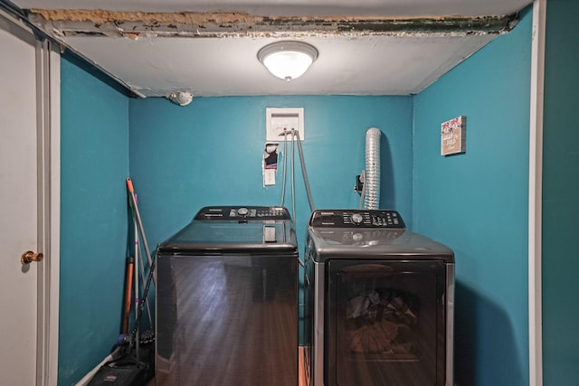 laundry area with wood finished floors, laundry area, and washing machine and clothes dryer